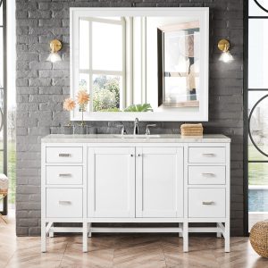 A modern bathroom showcases the Addison 60-inch Single Bathroom Vanity in Glossy White, paired with a large mirror. Two round lights illuminate the gray brick wall, while large windows provide outdoor views. A herringbone wood floor features a woven pouf and seat with toiletries beside the elegant vanity.