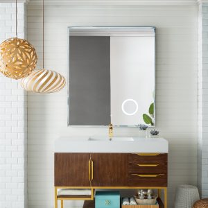 A modern bathroom showcases the Columbia 48 single bathroom vanity in coffee oak with radiant gold accents and a white countertop. A large mirror above reflects a ring light, while three spherical pendant lights hang from the ceiling. A small plant and toiletries are neatly arranged on the vanity.
