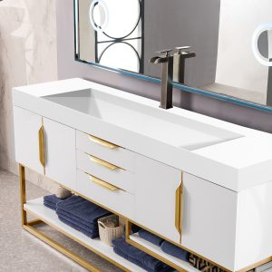 The Columbia 72 Single Bathroom Vanity in Glossy White features a sleek countertop, rectangular sink, radiant gold handles and base. It includes folded blue towels and a woven basket on the lower shelves. A mirror captures decorative elements.