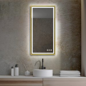A modern bathroom features a Stellar 18 Inch LED Light Bathroom Mirror above a sleek countertop. A round white sink with a black faucet is accompanied by a soap dispenser, small container, and reed diffuser. Soft towels are neatly stacked on the right.