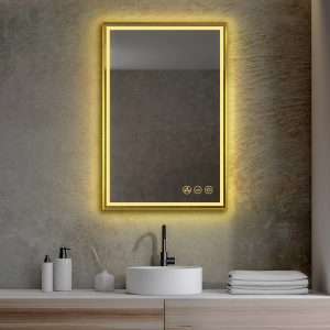 A sleek bathroom showcases the Stellar 24 Inch LED Light Bathroom Mirror with a yellow-lit border on a gray wall. Below is a white vessel sink paired with a matte black faucet, complemented by soap dispensers and orderly towels.