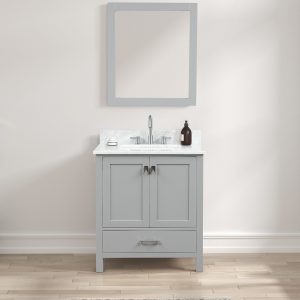 The Geneva 30 Bathroom Vanity in metal gray features two doors and a drawer, topped with a Carrara marble countertop and a rectangular mirror. A silver faucet sits beside a dark bottle on the left, against a plain cream wall and light wood flooring.
