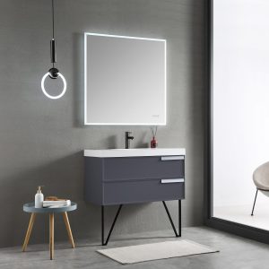 A minimalist bathroom showcases the Sofia 36 Wall Mount Vanity in Matte Gray, paired with a white sink and large square mirror. A round ceiling light, modern chair, and small table with toiletries complete this elegant retreat.