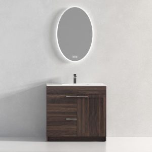 The Hanover 36 inch Bathroom Vanity in Cali Walnut features a dark wood cabinet with a single faucet against a light wall. Above the sink is a large, backlit oval mirror, showcasing minimalist design that blends modern and natural elements seamlessly.