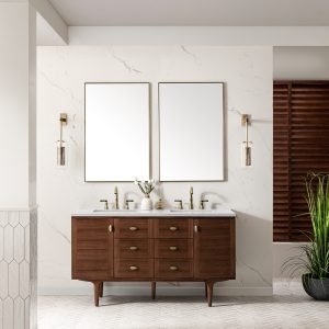 A modern bathroom showcases an Amberly 60 Double Vanity in Mid-Century Walnut with a White Zeus Top and brass handles. Two rectangular mirrors and wall-mounted lights hang above. The space includes a marble wall, hexagonal floor tiles, and a potted plant in the corner for an inviting oasis.