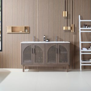 A modern bathroom features the Nara 60 inch Chestnut Oak Freestanding Bathroom Vanity, arched cabinet doors, a slatted wood wall, gold pendant lights, a white ladder shelf for toiletries and towels, and a small wall-mounted shelf.
