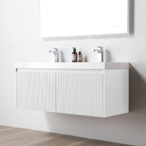 A modern Positano 48 inch Double Sink Wall Mount Bathroom Vanity in Matte White with sink is set against a plain white wall, topped with two faucets and a mirror, with soap and lotion on the counter above a light wood floor.