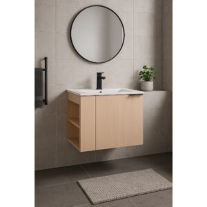 This modern bathroom showcases the Elmridge 24 Wall Mounted Bathroom Vanity with a sink, a black faucet, and a round mirror. A potted plant sits on the ledge, complemented by a dark towel on a black rack and a beige mat on dark tiles, highlighting its minimalist style.