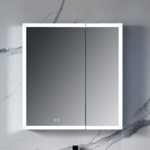 A Capella 30 inch LED Medicine Cabinet is mounted on a marble wall, featuring a thin white frame and subtle touch button for lighting control. The built-in lighting enhances the sleek design, while the gray veining of the marble adds elegance.