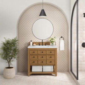 The bathroom showcases a Malibu 36 inch Bathroom Vanity Cabinet in Amber Birch, featuring eight drawers topped with a vase of white flowers. Above it hang a round mirror and black pendant light, complemented by arch-shaped neutral wallpaper and a small potted plant for a serene atmosphere.