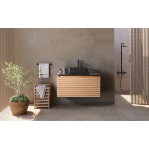 A minimalist bathroom features the Ocala 36 Inch Wall Mount Bathroom Vanity With Vessel Sink, a black sink, and wall-mounted faucet. A potted plant and towel basket sit to the left, with an open shower area and natural light illuminating the space.