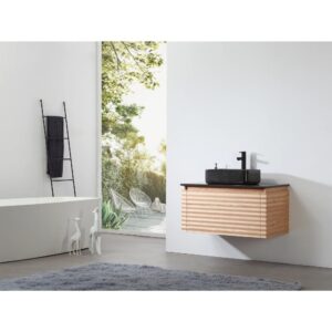 Minimalist bathroom with the Ocala 36 Inch Wall Mount Bathroom Vanity With Vessel Sink, a black sink, ladder towel rack, white bath, two white giraffe figures, and a large window overlooking a lush patio with outdoor chairs.