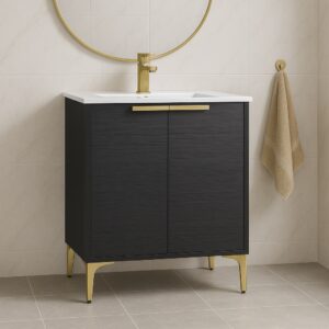 The modern bathroom highlights the Wilmington 24 Inch Bathroom Vanity With Sink, boasting a dark wood finish with gold accents and a pristine white basin. Above, a circular mirror with a gold frame complements the scene, set against an elegant backdrop of beige tiles.