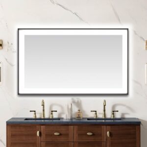 A modern bathroom features a Lexington 60 inch x 36 inch LED Lighted Slim Frame Mirror above a double sink vanity with a dark countertop, brass faucets, and marble-patterned walls.
