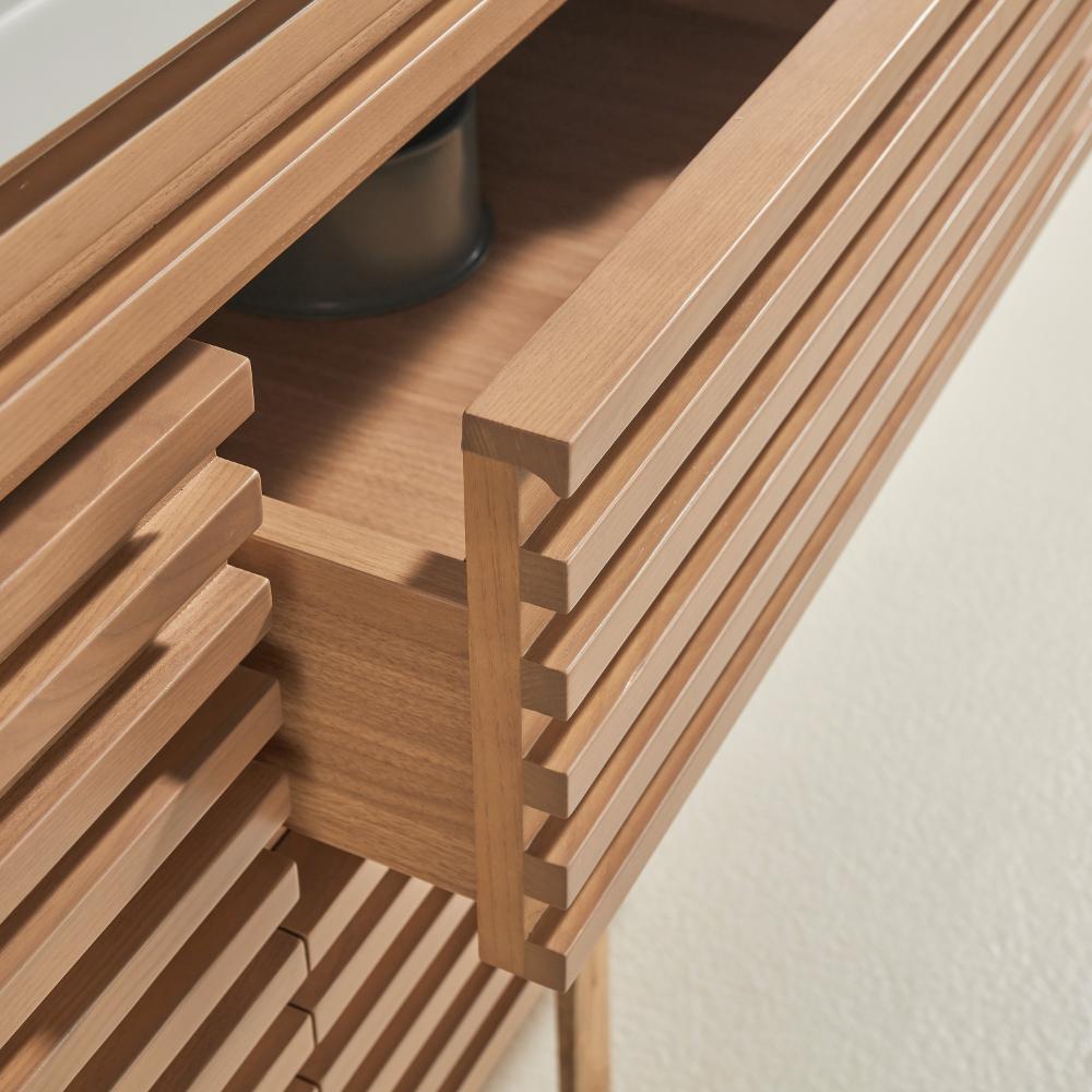 A close-up of the Linea 48 Inch Wall Mounted Bathroom Vanity with top, showing strip front design drawer fronts and one partially open drawer against a light-colored wall.