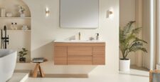Minimalist bathroom featuring the Linea 48 Inch Wall Mounted Bathroom Vanity, a rectangular mirror, modern lighting, potted plant, decorative shelves, and a white freestanding tub in a bright, neutral-toned space.