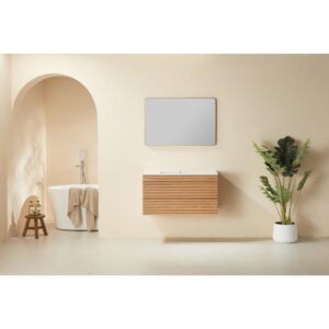 Minimalist bathroom with a light beige wall, a Linea 36 Inch Wall Mounted Bathroom Vanity, a rectangular mirror, a white potted plant, and an arched entrance to a bathtub with towel and bath accessories.